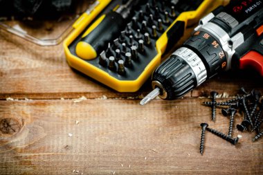 Working tools. Screwdriver bits. On a wooden background. High quality photo