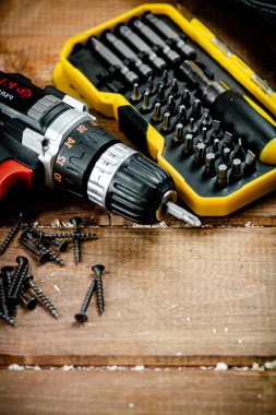 Working tools. Screwdriver bits. On a wooden background. High quality photo