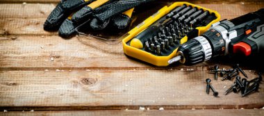 Working tools. Screwdriver bits. On a wooden background. High quality photo