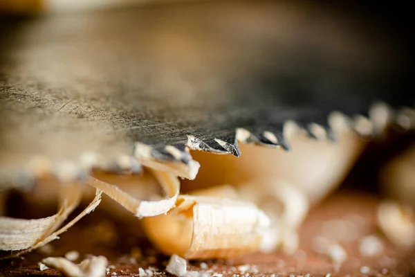 stock image Hand saw blade on a wooden background. High quality photo