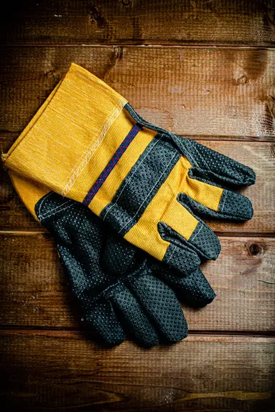 Pair Construction Gloves Table Wooden Background High Quality Photo ストック写真