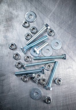 Nuts and bolts on the table. On a gray background. High quality photo