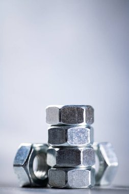 Working tool. Metal nuts on the table. On a gray background. High quality photo