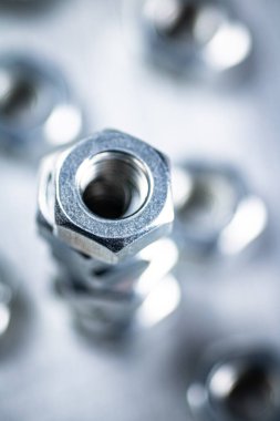 Working tool. Metal nuts on the table. On a gray background. High quality photo
