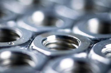 Working tool. Metal nuts on the table. On a gray background. High quality photo