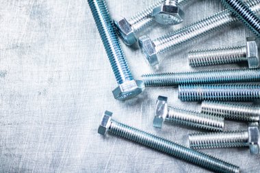 Working tool. Bolts on a gray background. High quality photo
