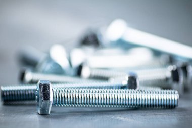 Working tool. Bolts on a gray background. High quality photo