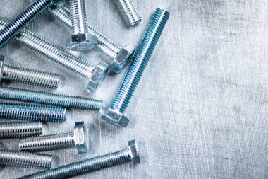 Working tool. Bolts on a gray background. High quality photo