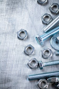 Working tool. Nuts and bolts on the table. On a gray background. High quality photo