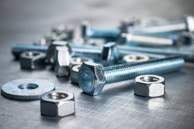 Working tool. Nuts and bolts on the table. On a gray background. High quality photo
