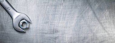 Metal wrench on the table. On a gray background. High quality photo