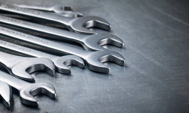 Metal wrench on the table. On a gray background. High quality photo