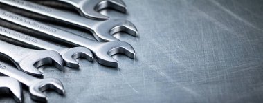 Metal wrench on the table. On a gray background. High quality photo