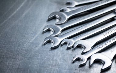 Metal wrench on the table. On a gray background. High quality photo