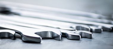 Metal wrench on the table. On a gray background. High quality photo