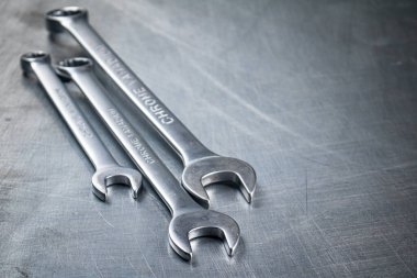 Metal wrench on the table. On a gray background. High quality photo