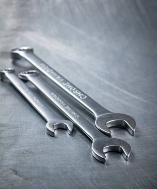 Metal wrench on the table. On a gray background. High quality photo