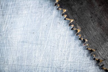 The blade of a hand saw on a gray background. High quality photo