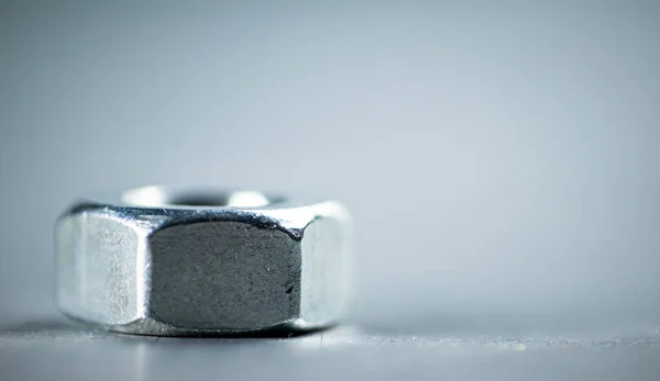 stock image Working tool. Metal nuts on the table. On a gray background. High quality photo