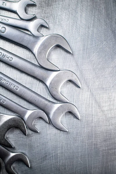 Metal wrench on the table. On a gray background. High quality photo