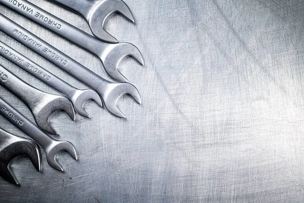 Metal wrench on the table. On a gray background. High quality photo