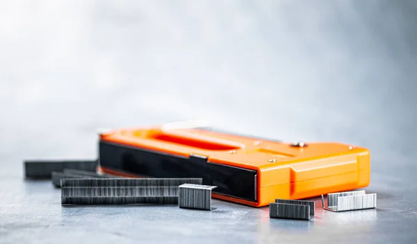 stock image Construction stapler on the table. On a gray background. High quality photo