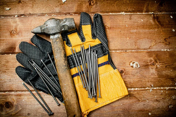Nails Hammer Gloves Wooden Background High Quality Photo — Stock fotografie