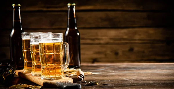 stock image Glasses of beer with dried fish. On wooden board.