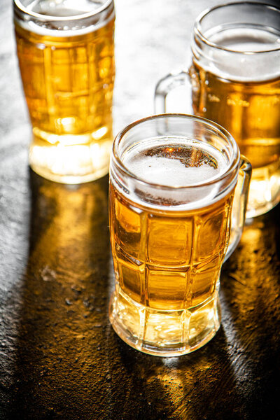 Glasses with beer . On rustic background.