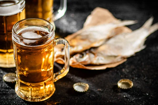 stock image Beer with dried fish. On rustic background.