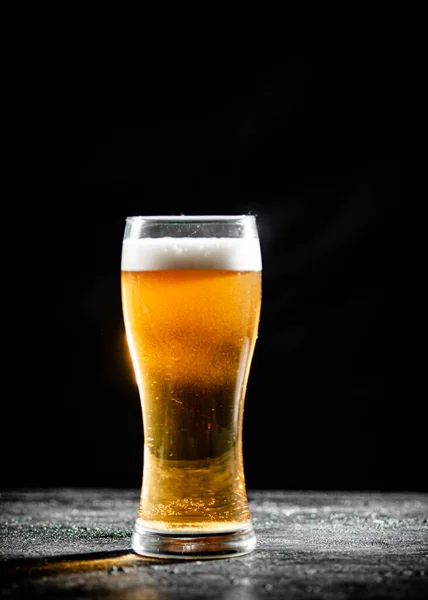 stock image Glass with beer . On rustic background.