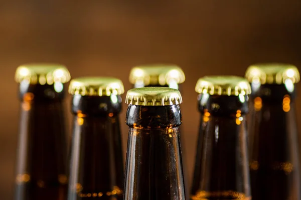 stock image Beer bottles. On wooden background.