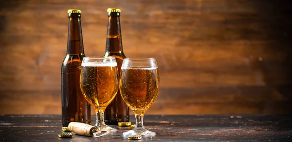 stock image Glasses with fresh beer. On rustic background.