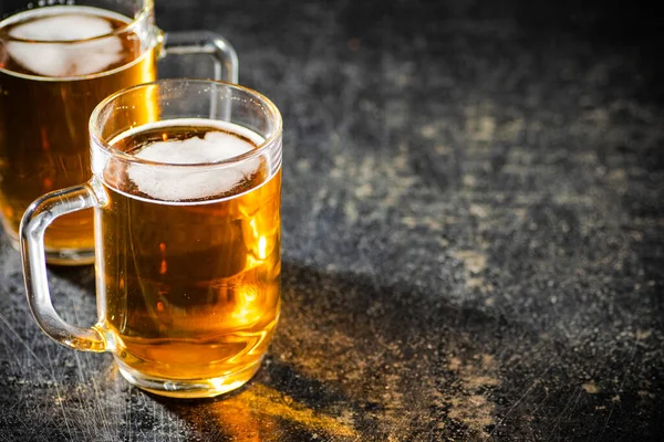 stock image Fresh beer in glasses. On stone background.