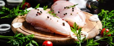 Baharatlı taze tavuk filetosu. Siyah bir masada..