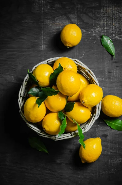 Fresh lemons. On a black table.