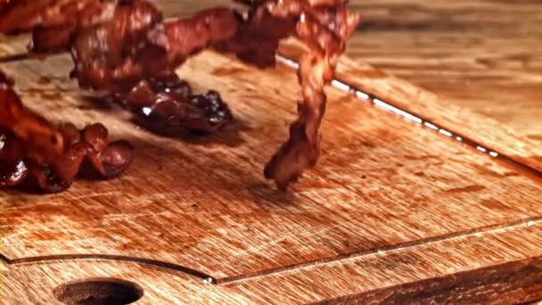 Roasted Slices Bacon Fall Wooden Table Filmed High Speed Camera — Stock Video