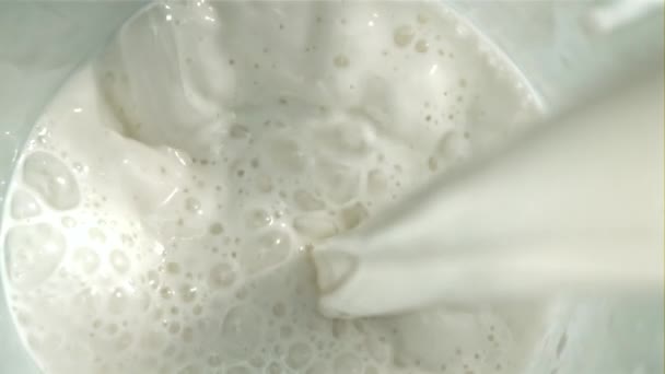 牛乳はスプラッシュでガラスに注ぎ込まれています トップビュー 1000Fpsで高速カメラで撮影しました 高品質のフルHd映像 — ストック動画