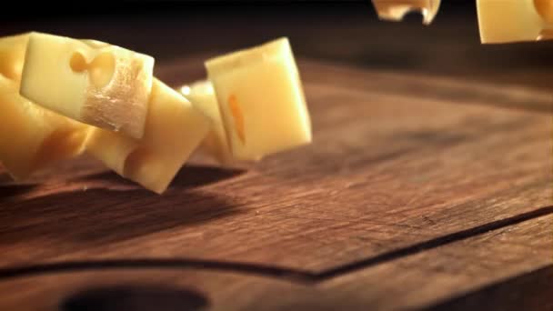 Super Slow Motion Pieces Cheese Fall Cutting Board Filmed High — Stock Video