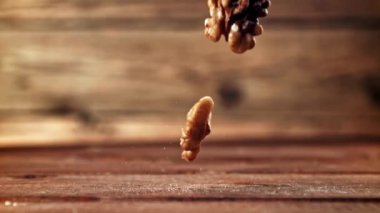 Süper yavaş çekimde soyulmuş cevizler masaya düşer. Yüksek kaliteli FullHD görüntüler