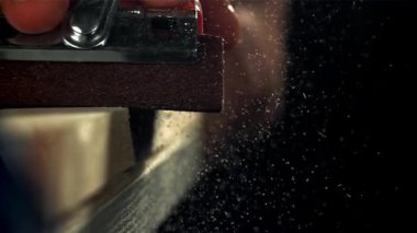 Bir marangoz ahşap bir kalas kumlar. 1000 fps 'de yüksek hızlı bir kamerayla çekildi. Yüksek kaliteli FullHD görüntüler