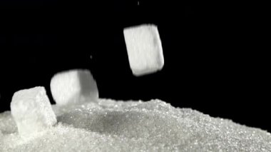 Şeker küpleri şeker yığınına düşer. 1000 fps 'de yüksek hızlı bir kamerayla çekildi. Yüksek kaliteli FullHD görüntüler