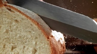 Şef taze ekmek dilimler. 1000 fps 'de yüksek hızlı bir kamerayla çekildi. Yüksek kaliteli FullHD görüntüler