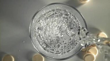 Su bir bardağa doldurulur. 1000 fps 'de yüksek hızlı bir kamerayla çekildi. Yüksek kaliteli FullHD görüntüler