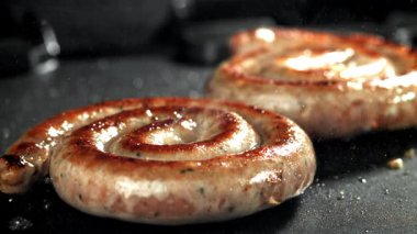 Sosisler ızgara. 1000 fps 'de yüksek hızlı bir kamerayla çekildi. Yüksek kaliteli FullHD görüntüler
