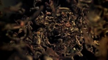 Kuru çay yaprakları dökülüyor. 1000 fps 'de yüksek hızlı bir kamerayla çekildi. Yüksek kaliteli FullHD görüntüler