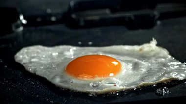 Yumurta tavada kızarır. 1000 fps 'de yüksek hızlı bir kamerayla çekildi. Yüksek kaliteli FullHD görüntüler