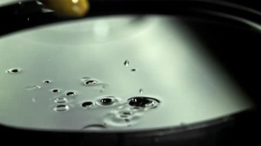 Zeytinler su sıçraması ile masaya düşer. 1000 fps 'de yüksek hızlı bir kamerayla çekildi. Yüksek kaliteli FullHD görüntüler