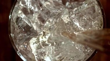 Viski buzlu bir bardağa dökülür. 1000 fps 'de yüksek hızlı bir kamerayla çekildi. Yüksek kaliteli FullHD görüntüler