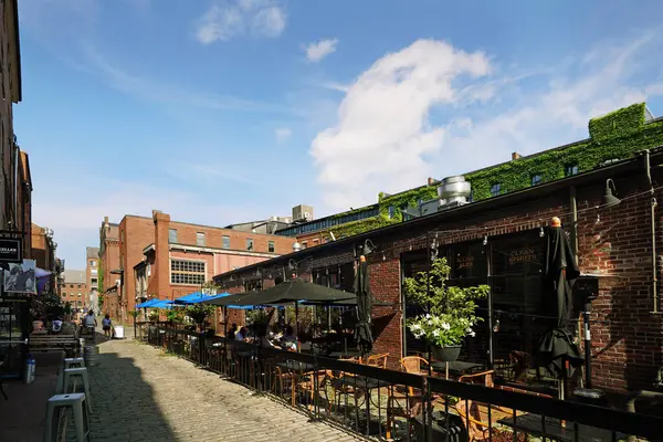 stock image Portland, ME - USA - 08-03-2024: People enjoying the outdoor summer dining at restaurants along Wharf St in downtown Portland Maine.